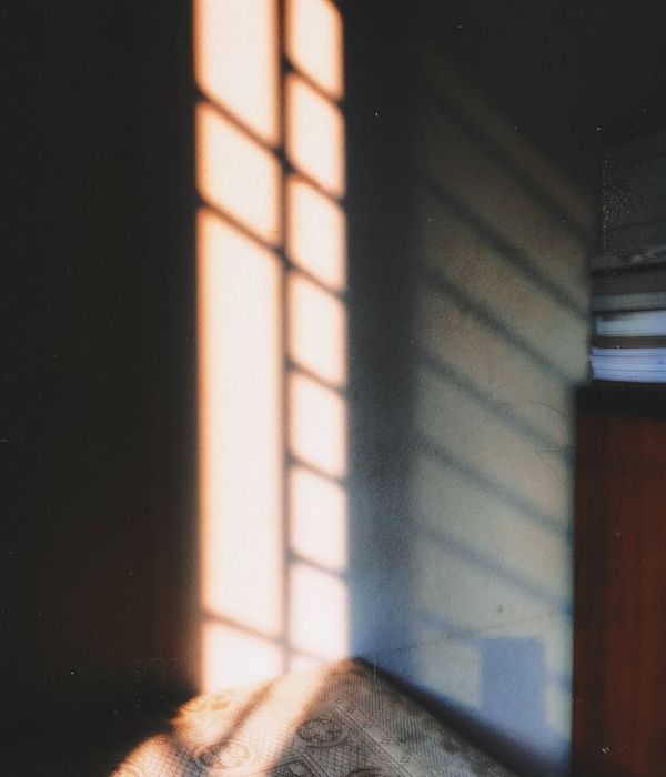Cozy corner in a room with a yoga mat, plants, and soft morning light.