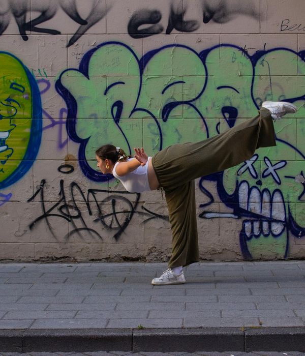 Woman in a vibrant yoga pose, feeling energetic and balanced outdoors.